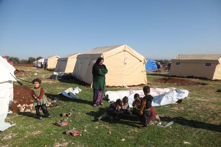 Samaher Rashid and kids in front of the tents