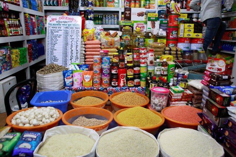 A grocery shop in Dhaka with gunny sacks of rice and lentils