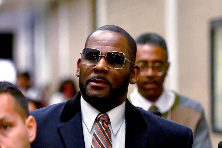 US singer R Kelly leaves a hearing in 2019
