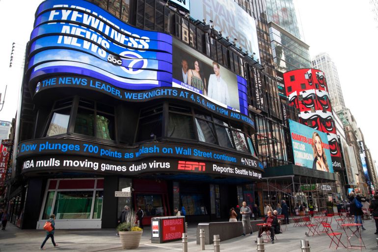 An electronic ticker displays news Wednesday, March 11, 2020, in New York's Times Square