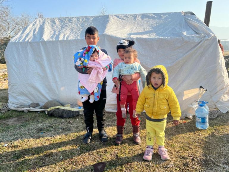 Children in front of a tent in a makeshift camp in Osmaniye, Turkey, on Tuesday, February 14, 2023 [Patrick Keddie/Al Jazeera]