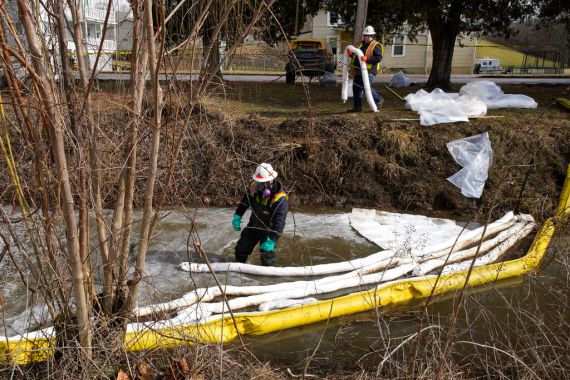 A worker conducts cleanup in a stream in East Palestine, Ohio