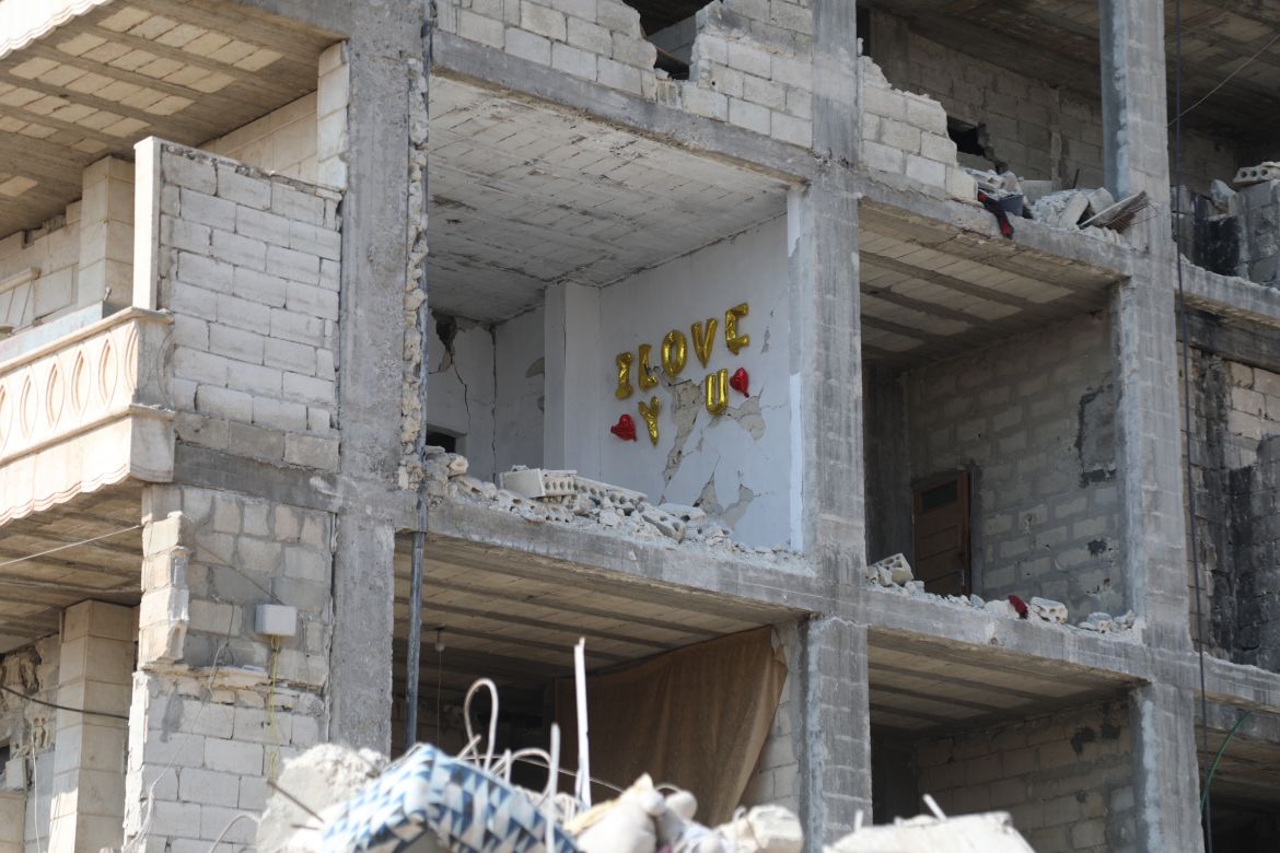 Balloons spelling out 'I love you' can be seen on the wall of a destroyed building in Jandaris, Syria.
