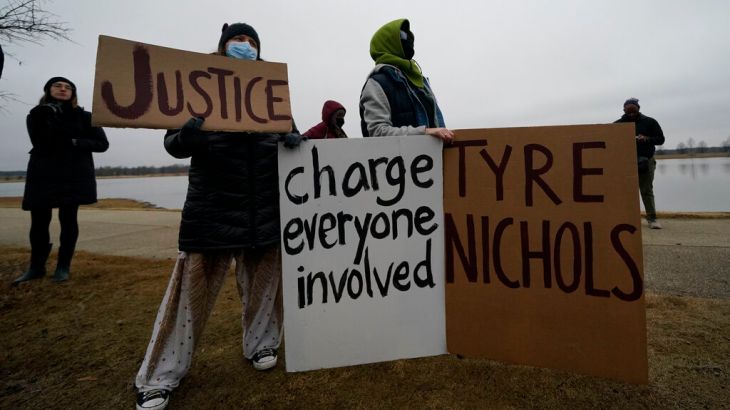 Demonstrators in Memphis hold signs calling for charges against those involved in arrest of Tyre Nichols