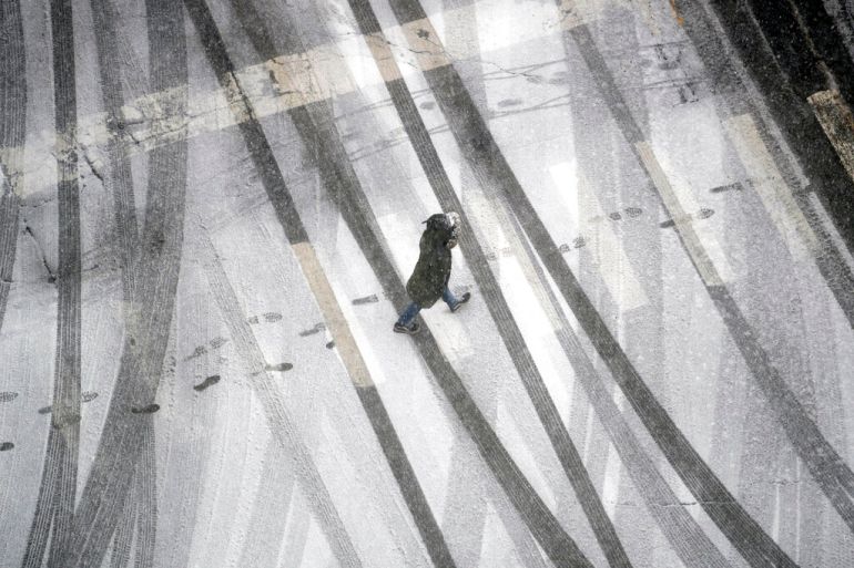 A person crosses a frosty street