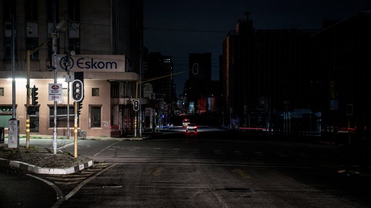 An illuminated signboard on a street corner in Johannesburg.