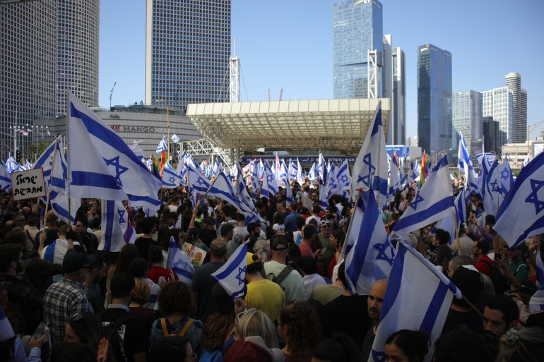 A crowd of protesters with Israeli flags