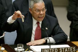 U.S. Secretary of State Colin Powell holds up a vial that he described as one that could contain anthrax, during his presentation on [Iraq] to the U.N. Security Council, in New York February 5, 2003. [Powell tried to persuade a sceptical world that Iraq is concealing it's weapons of mass destruction and that force may be necessary to disarm it.]