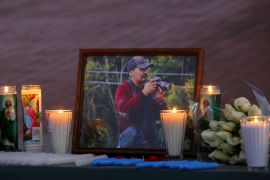 A view shows candles lit and a picture of late Mexican photojournalist Margarito Martinez, 49, who was killed outside his home by unknown assailants, as journalists take part in a vigil honouring him, in Tijuana, Mexico January 21, 2022.