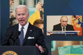 Russia's President Vladimir Putin is seen on a display in the background as U.S. President Joe Biden speaks about "gas prices and Putin's Price Hike" during remarks in the Eisenhower Executive Office Building's South Court Auditorium at the White House in Washington, U.S., June 22, 2022. REUTERS/Kevin Lamarque