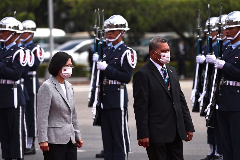 Tuvalu Prime Minister Kausea Natano at the official welcome ceremony in Taipei.  He was walking with Taiwan President Tsai Ing-wen past soldiers in blue uniforms with white hats and gloves