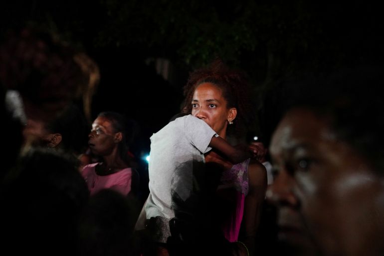 A woman holds a child during a protest during blackouts in the aftermath of Hurricane Ian, in Havana, Cuba