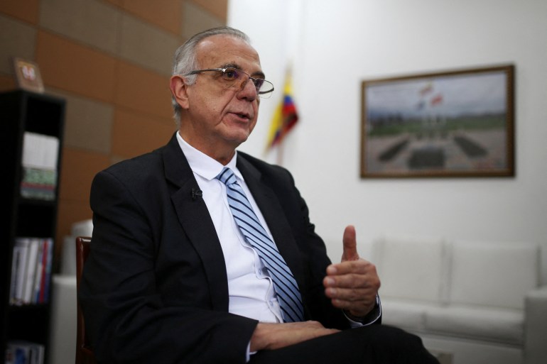 Minister Ivan Velasquez speaks, sitting in an office