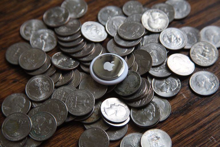 An AirTag sits atop a pile of US quarter coins