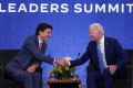 Canadian Prime Minister Justin Trudeau shakes hands with US President Joe Biden in Mexico City