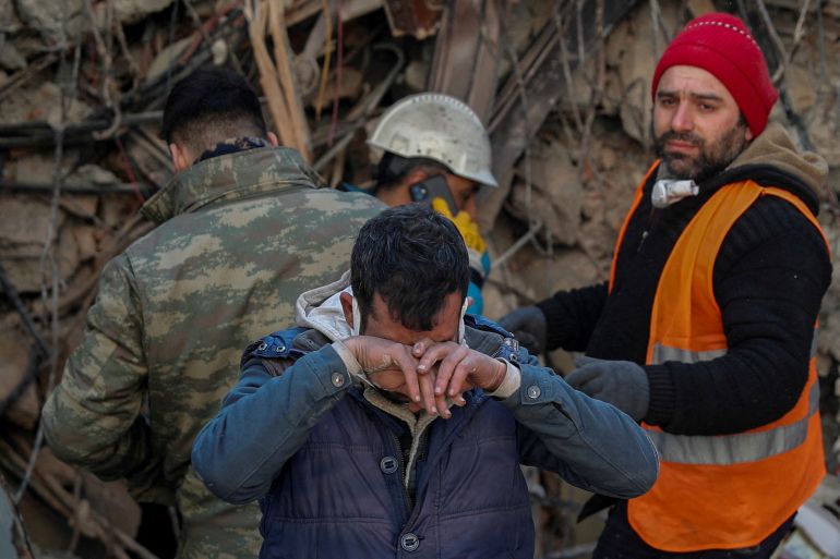 Brother of survivor Gokhan Ugurlu, 35, reacts as rescuers work in the aftermath of a deadly earthquake