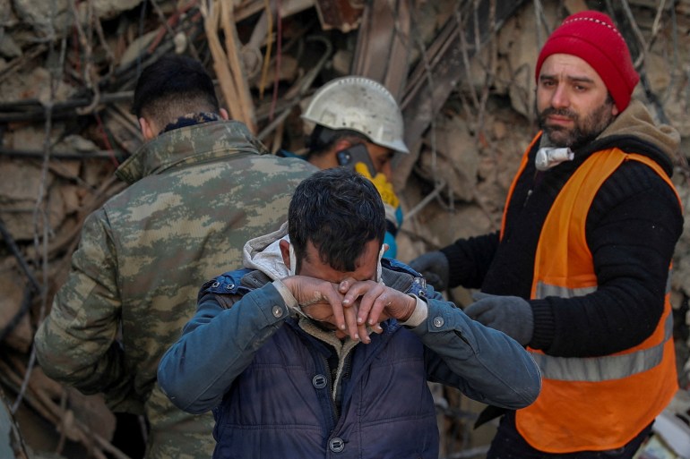 Brother of survivor Gokhan Ugurlu, 35, reacts as rescuers work in the aftermath of a deadly earthquake