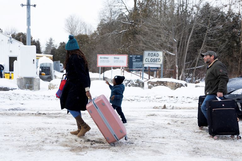 Asylum seekers arrive by taxi to cross into Canada from the US border on Roxham Road between New York state and Quebec