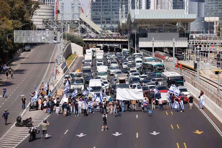 Israeli protesters stop traffic as they demonstrate as Israeli Prime Minister Benjamin Netanyahu's nationalist coalition government presses on with its contentious judicial overhaul, in Tel Aviv, Israel, March 1, 2023