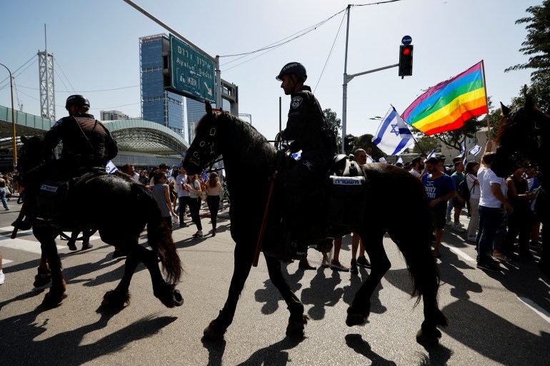 Israeli police ride horses as they patrol a demonstration as Israeli Prime Minister Benjamin Netanyahu's nationalist coalition government presses on with its contentious judicial overhaul, in Tel Aviv, Israel, March 1, 2023.