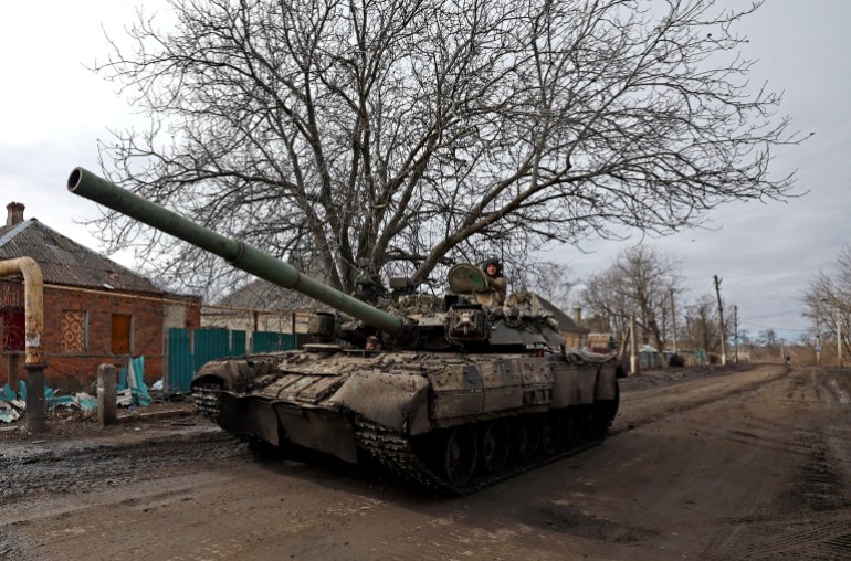 Ukrainian forces drive a tank