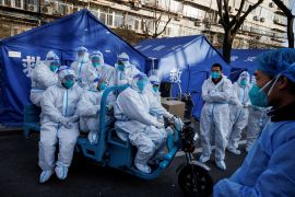 FILE PHOTO: Pandemic prevention workers leave for their shift to look after buildings where residents do home quarantine, as coronavirus disease (COVID-19) outbreaks continue in Beijing, December 8, 2022. REUTERS/Thomas Peter/File Photo