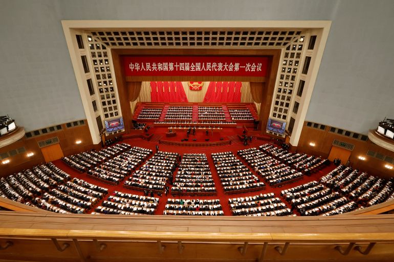Chinese officials and delegates attend the opening session of the National People's Congress at the Great Hall of the People in Beijing, China.