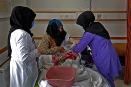 A trainee midwife examines a woman at a hospital in Bamiyan, Afghanistan