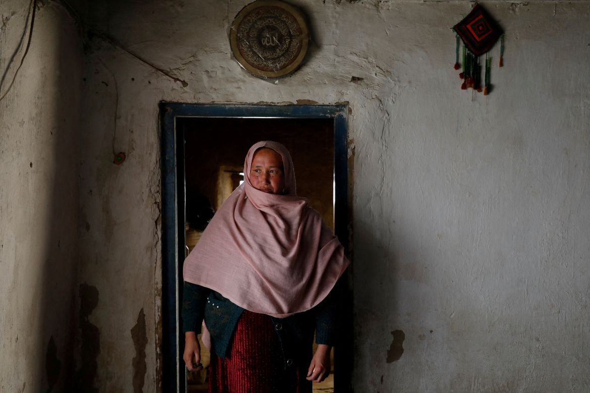 Aziza Rahimi, 35, who lost her son at birth, walks inside her house in Foladi Valley in Bamiyan, Afghanistan