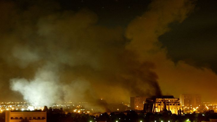 Smoke billows from a presidential palace compound in Baghdad during air strikes, Iraq March 21, 2003.