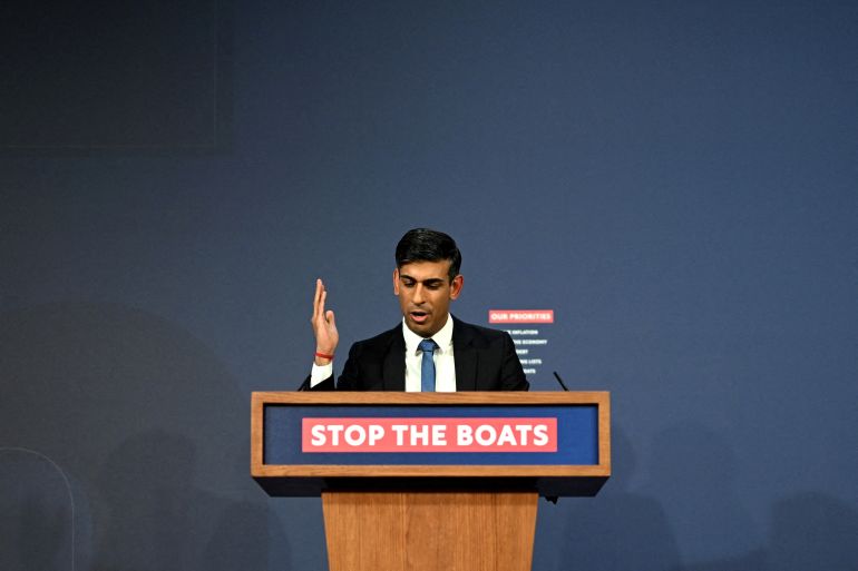 Prime Minister Rishi Sunak speaks during a press conference following the launch of new legislation on refugee and migrant channel crossings at Downing Street on March 7, 2023 in London, United Kingdom. A slogan on the lectern he is speaking from reads 'Stop the boats'.