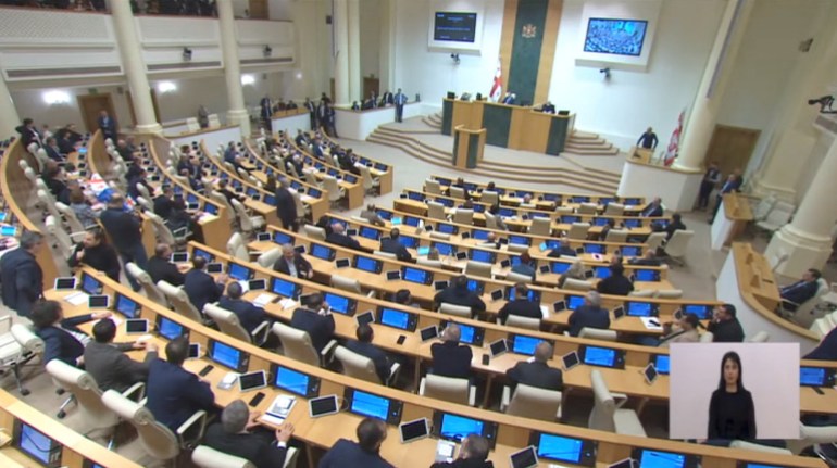 Lawmakers attend a plenary session of parliament where they vote on controversial 'foreign agents' bill that sparked mass protests in recent days, in Tbilisi, Georgia March 10, 2023