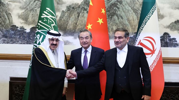 China's Wang Yi, Iran's Ali Shamkhani and Saudi Arabia's Musaad bin Mohammed Al Aiban pose for pictures