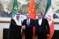 China's Wang Yi, Iran's Ali Shamkhani, and Saudi Arabia's Musaad bin Mohammed Al Aiban pose for pictures during a meeting in Beijing, China March 10, 2023.