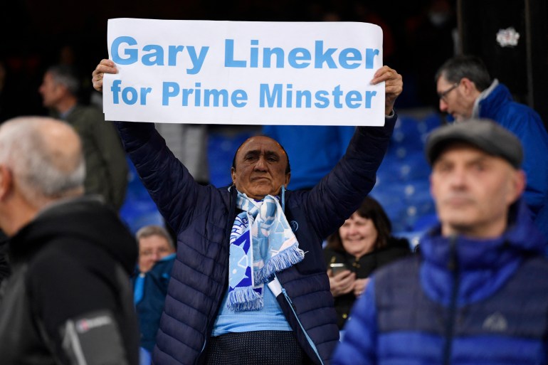 Soccer Football - Premier League - Crystal Palace v Manchester City - Selhurst Park, London, Britain - March 11, 2023 Manchester City fan with a sign in support of BBC presenter Gary Lineker inside the stadium before the match REUTERS/Tony Obrien EDITORIAL USE ONLY. No use with unauthorized audio, video, data, fixture lists, club/league logos or 'live' services. Online in-match use limited to 75 images, no video emulation. No use in betting, games or single club /league/player publications. Please contact your account representative for further details.