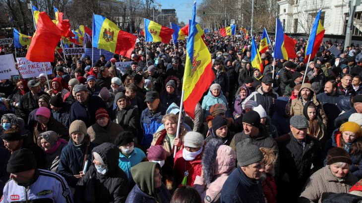 Hundreds of demonstrators in the Moldovan capital. Many are carrying Moldovan flags.