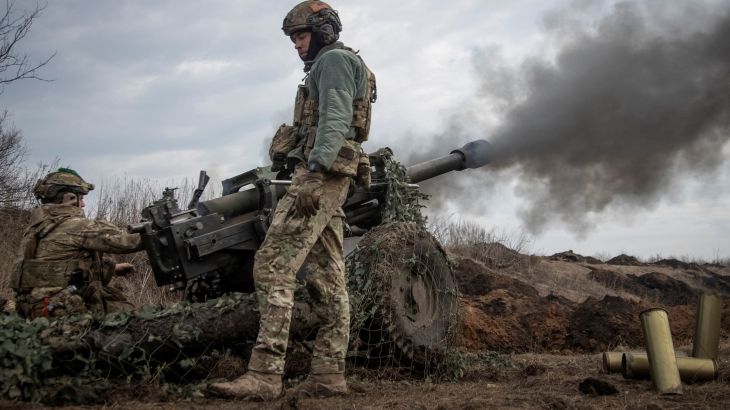 FILE PHOTO: Ukrainian service members fire a howitzer M119 at a front line, amid Russia's attack on Ukraine, near the city of Bakhmut, Ukraine.