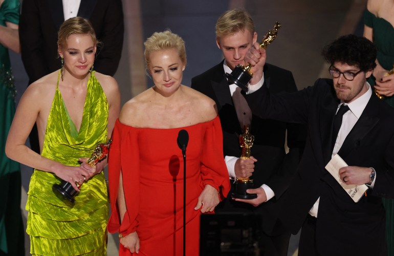 Yulia Navalny, wife of jailed dissident Alexei Navalny, speaks next to her daughter Daria and director Daniel Roher after "Navalny" was awarded for Best Documentary Feature Film during the Oscars show at the 95th Academy Awards in Hollywood, Los Angeles, California