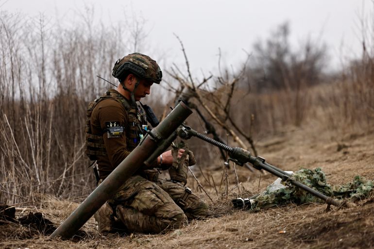 A Ukrainian soldier of the Paratroopers' of 80th brigade awaits order to fire a mortar shell at a frontline position near Bakhmut, amid Russia's attack on Ukraine, in Donetsk region, Ukraine