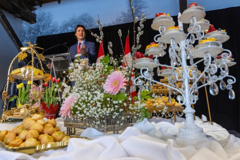 Canada’s Prime Minister Justin Trudeau speaks in front of the Haft-sin table at the Persian community’s Nowruz New Year 