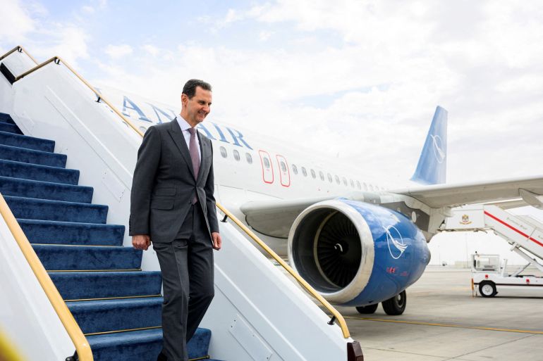 Syrian President Bashar al-Assad steps off a plane at he Presidential Airport in Abu Dhabi