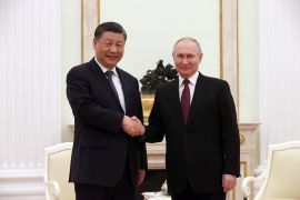 Russian President Vladimir Putin shakes hands with Chinese President Xi Jinping during a meeting at the Kremlin in Moscow [Sergei Karpukhin/Pool/Reuters]