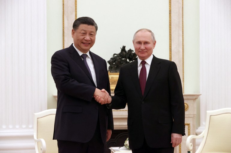 Russian President Vladimir Putin shakes hands with Chinese President Xi Jinping during a meeting at the Kremlin in Moscow, Russia