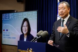 Taiwan Vice Foreign Minister Alexander Yui speaks next to a photo of President Tsai Ing-wen on Tuesday [Carlos Garcia Rawlins/Reuters]