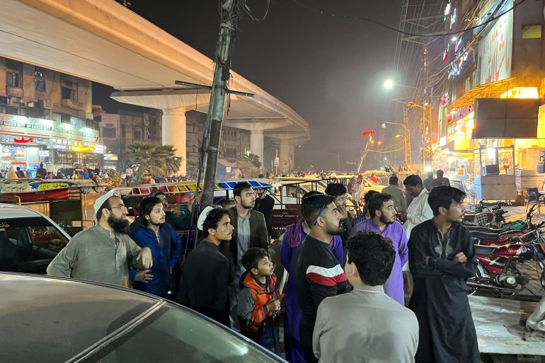 People come out of a restaurant in Lahore
