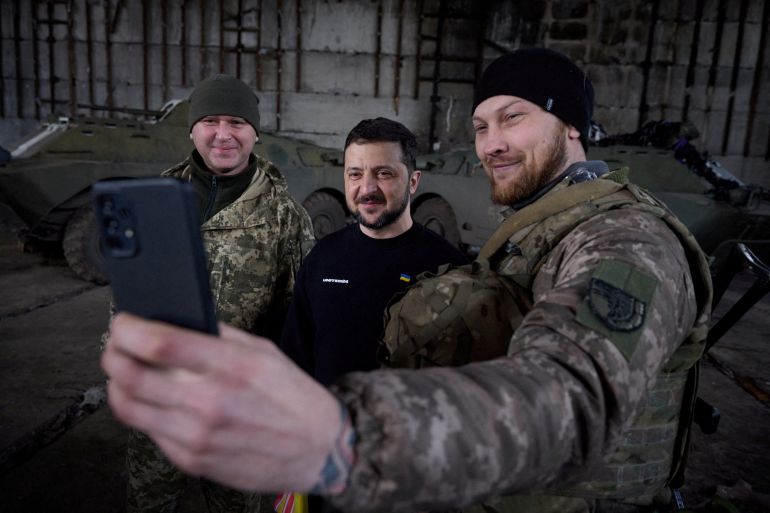Ukraine's President Volodymyr Zelenskiy poses for a picture with Ukrainian service members at a position near a frontline, amid Russia's attack on Ukraine, in Donetsk region, Ukraine March 22, 2023. Ukrainian Presidential Press Service/Handout via REUTERS ATTENTION EDITORS - THIS IMAGE HAS BEEN SUPPLIED BY A THIRD PARTY. TPX IMAGES OF THE DAY