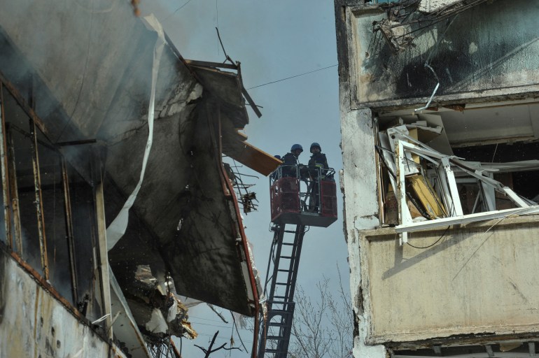 Rescuers work at a site of a residential building 