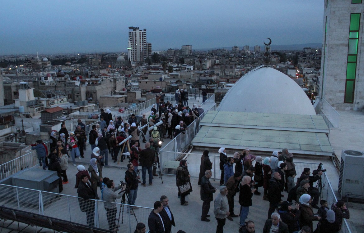 People and members of the Syrian astronomical association gather to observe the moon sighting that marks the beginning of the holy month of Ramadan in Damascus, Syria
