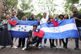 A group of Honduran and Taiwanese people pose for pictures during a gathering in support of relations between Taiwan and Honduras, at the campus of National Taiwan University, in Taipei, March 25, 2023 [I-Hwa Cheng/Reuters]
