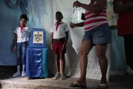 A woman walks to cast her vote at a polling station in Cuba